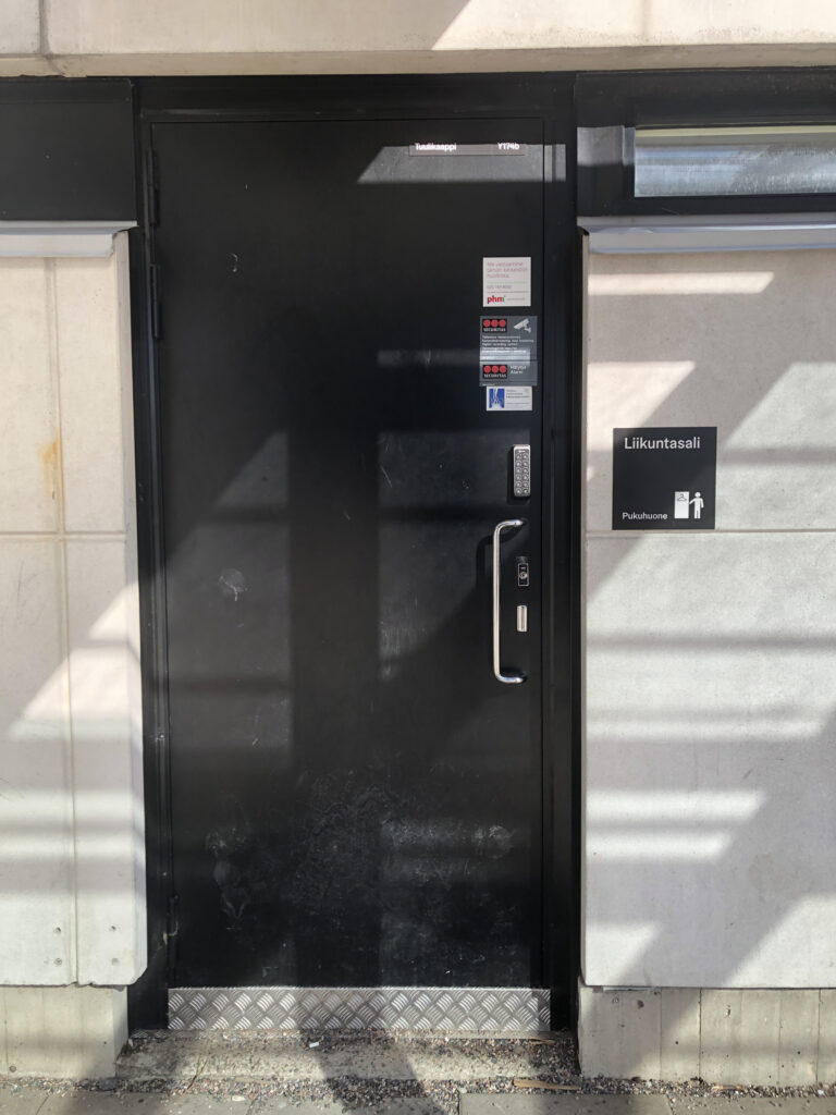 Picture of the door to mens locker room.